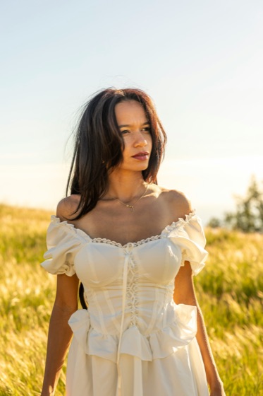 A portrait of a woman in a white dress, before and after background removal with Sweepcut
