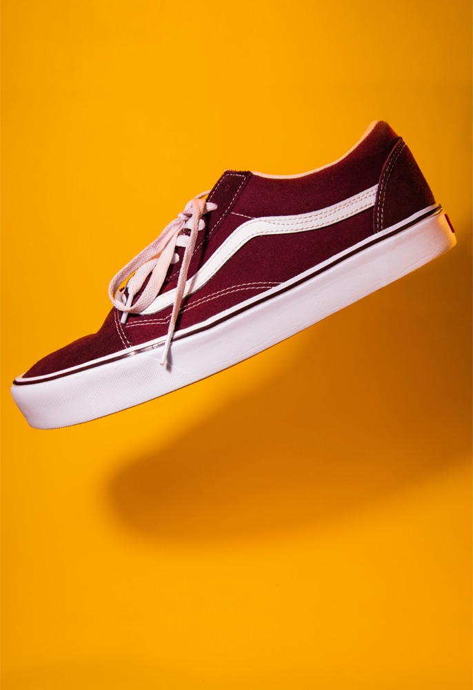 A burgundy sneaker photographed on orange, and the same sneaker cut out by Sweepcut